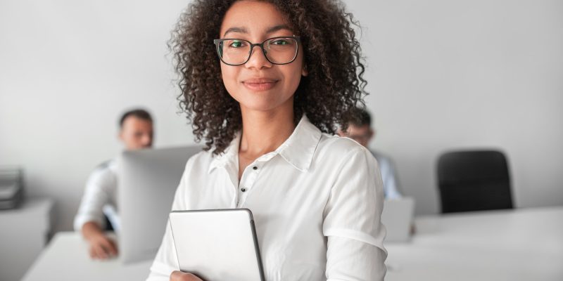 smiling-ethnic-female-recruiter-with-tablet-looking-at-camera-in-office.jpg
