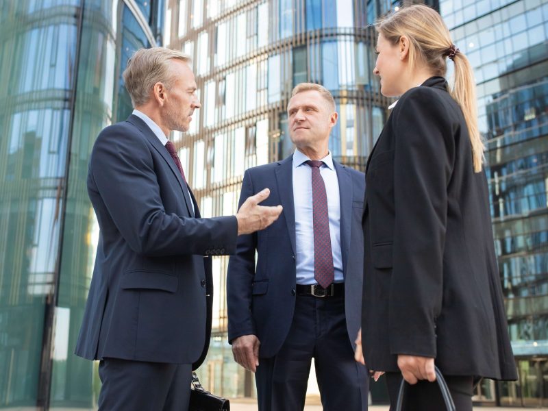team-business-people-meeting-city-standing-talking-office-buildings-discussing-contract-low-angle-shot_11zon team-business-people-meeting-city-standing-talking-office-buildings-discussing-contract-low-angle-shot_11zon